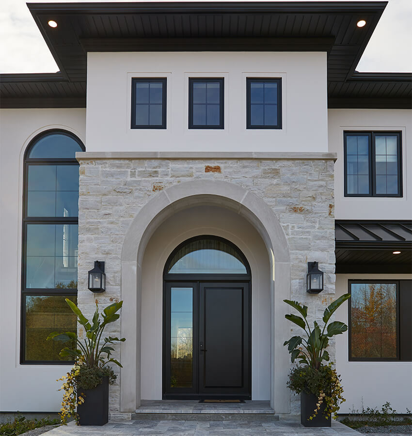 Luxury Stucco Entry With Arched Doors