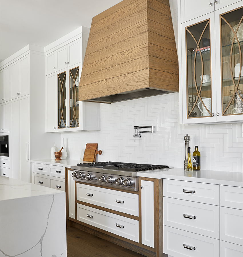 Luxury White Kitchen with Stainless Steel Appliances and Range Hood