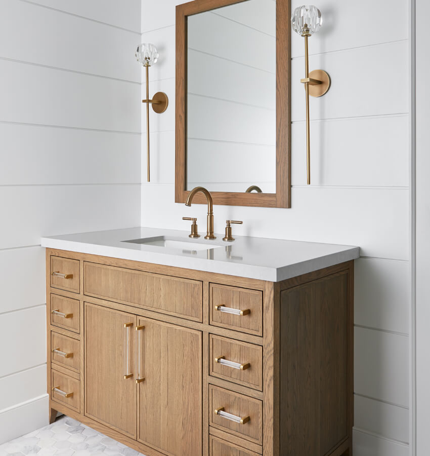 Shiplap walls with warm wood vanity and elegant sconces